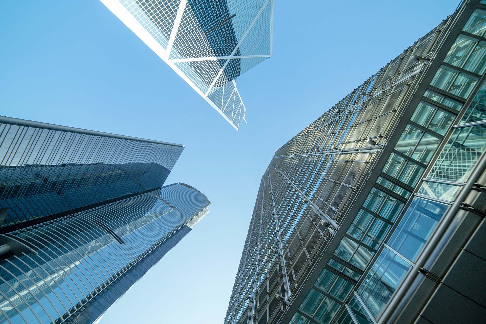 office building exteriors shot from the ground with the buildings towering up towards the sky