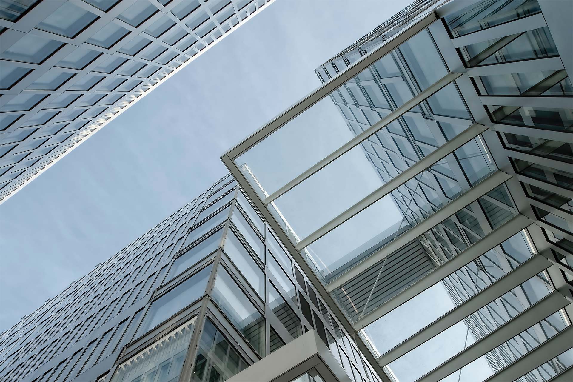 office building exteriors shot from the ground with the buildings towering up towards the sky