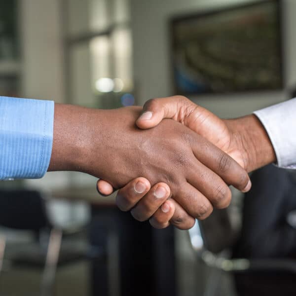 a closeup of two people shaking hands