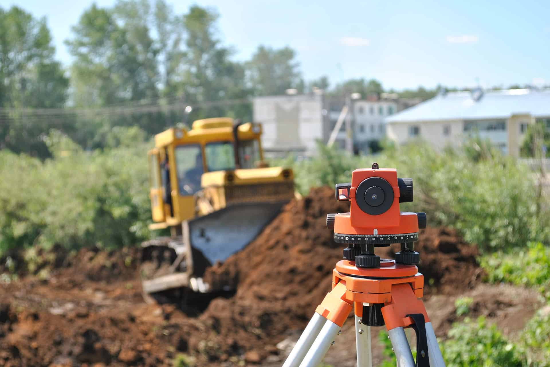 a construction site with an industrial camera on a tripod