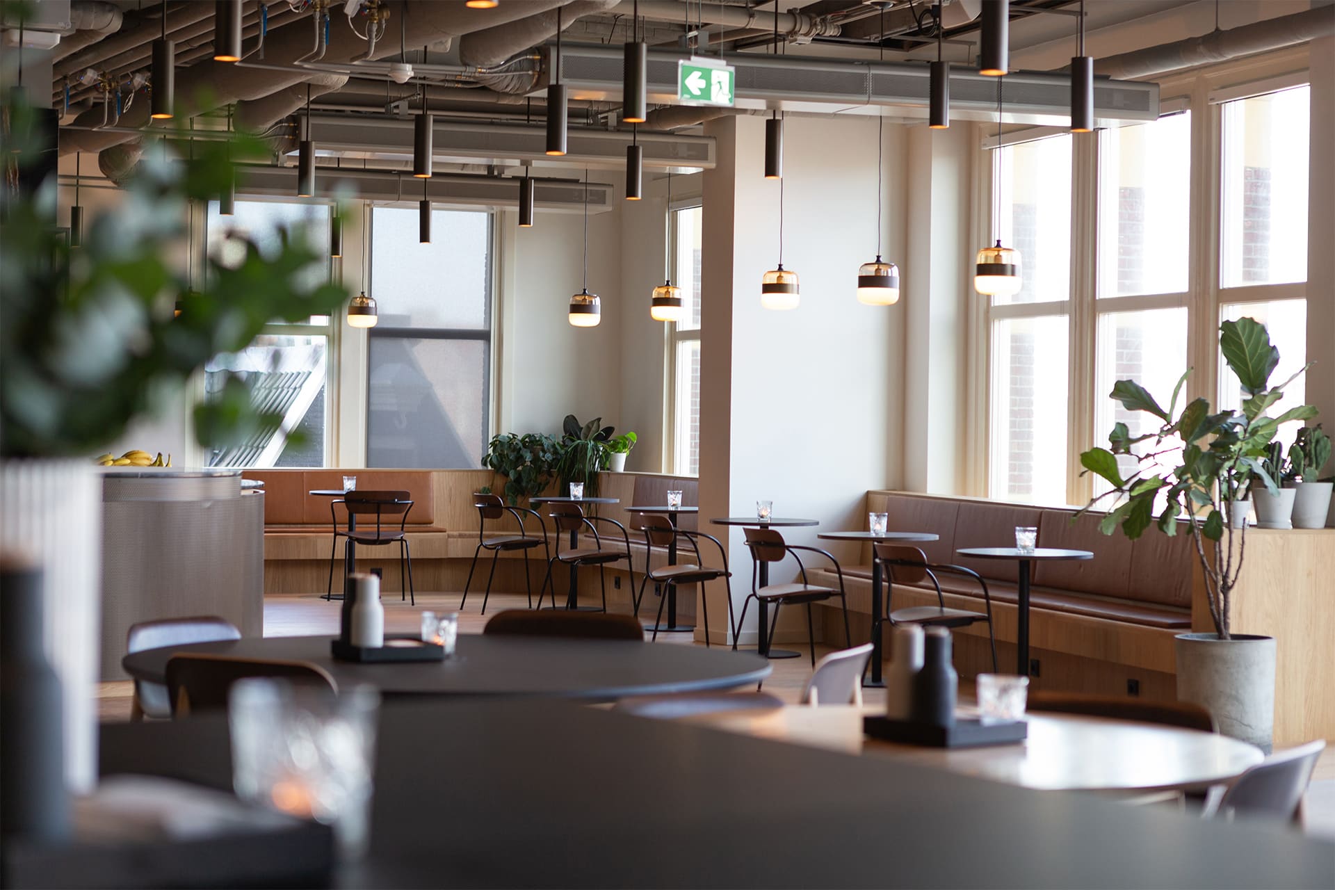 retail space with small restaurant tables set up around the edges