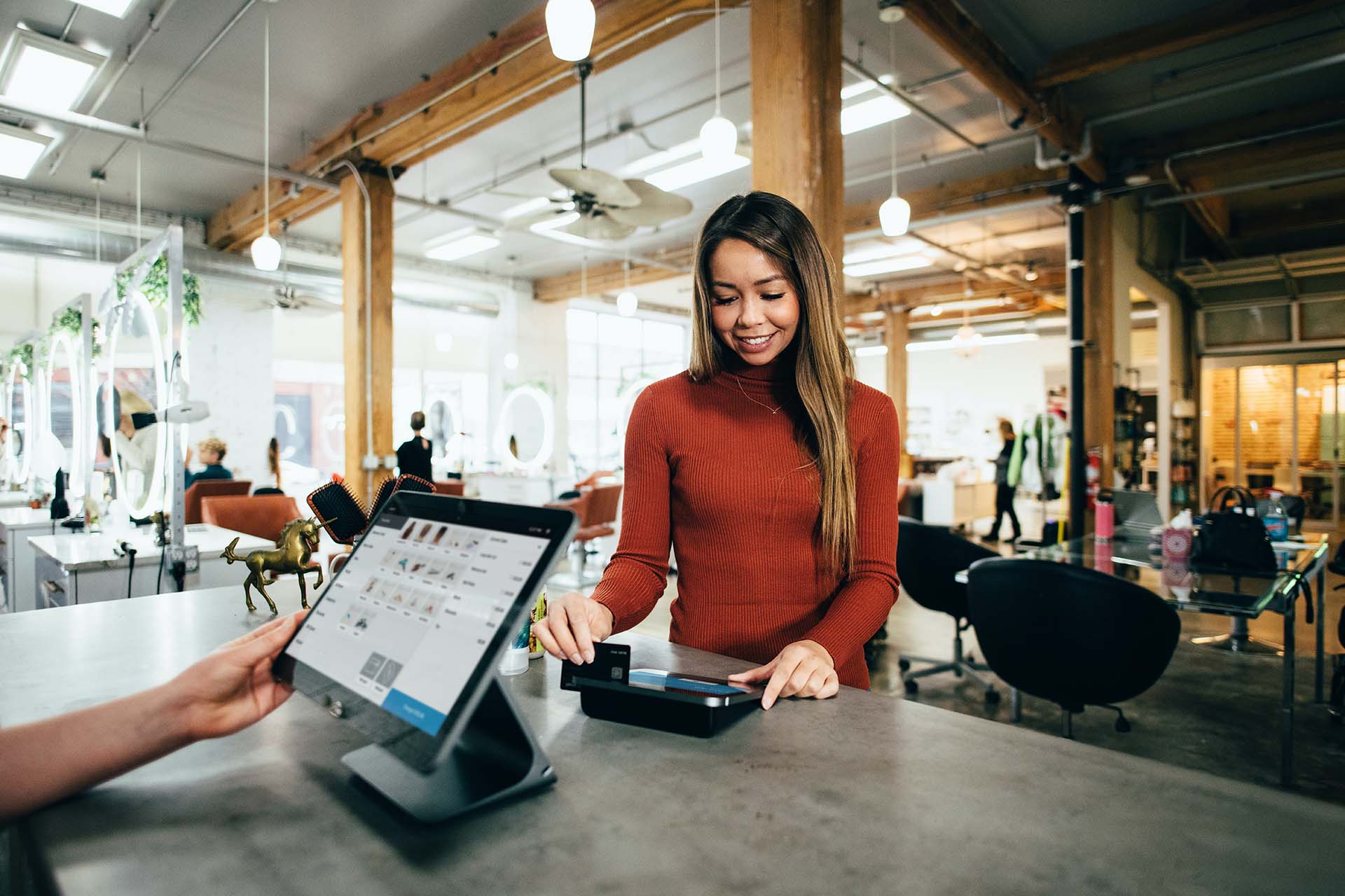 Retail space with a customer making a purchase at the register